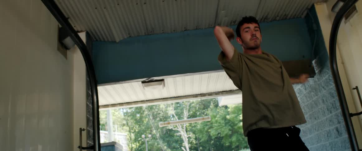 A man is dancing in a garage in spring