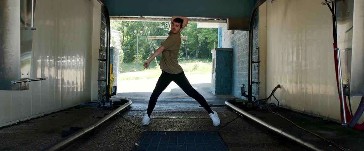 Man performs dance moves inside of a tunnel