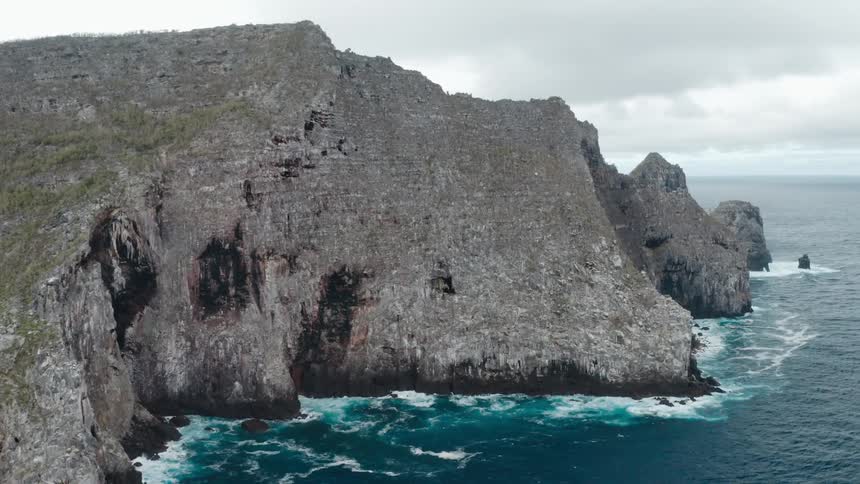 The waves are splashing against the rocks
