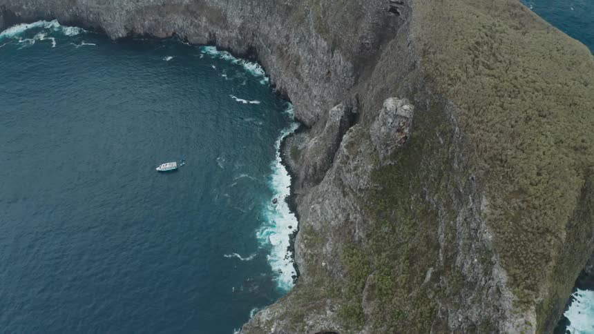 A boat is near the small island
