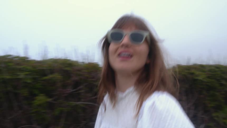 A woman walking outdoors having fun
