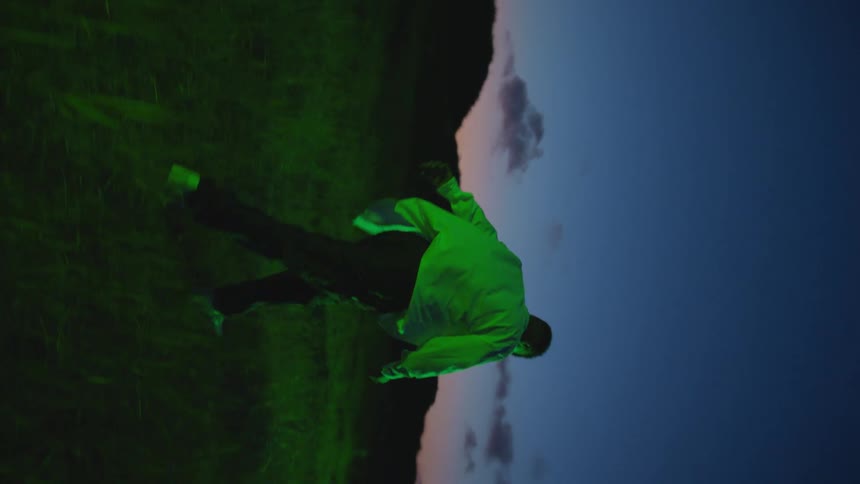 A man stumbles as he walks through a field