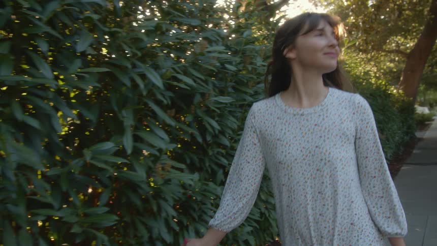 A woman walking outside and smiling