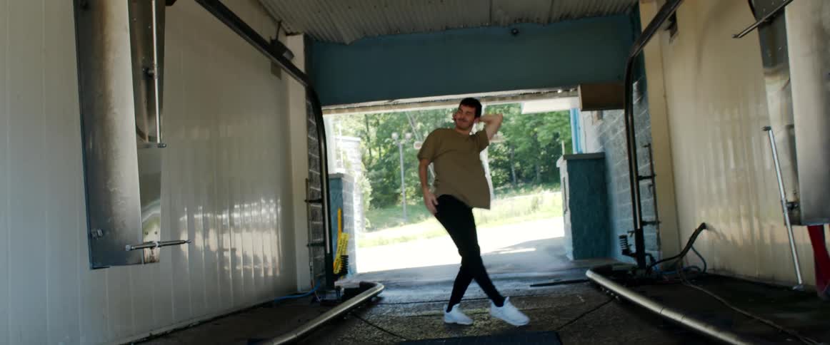 A man dancing in a car wash