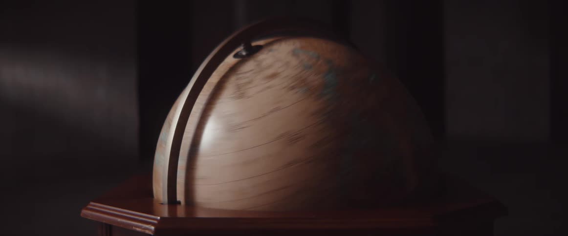 Old style world globe spinning fast and coming to a stop