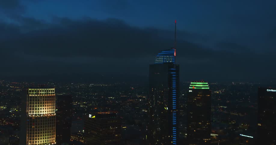 A city skyline with buildings and skyscrapers with the sky and clouds in the background