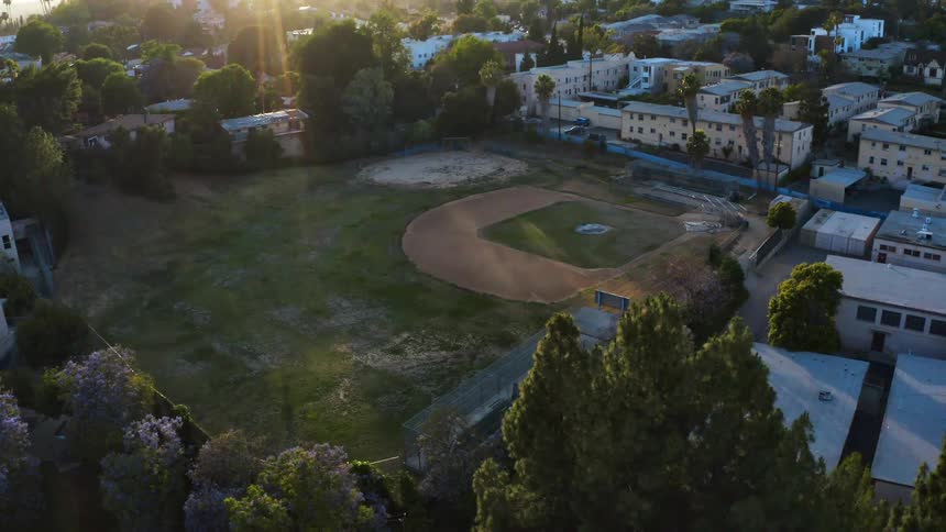Ball diamond sits near the trees and buildings
