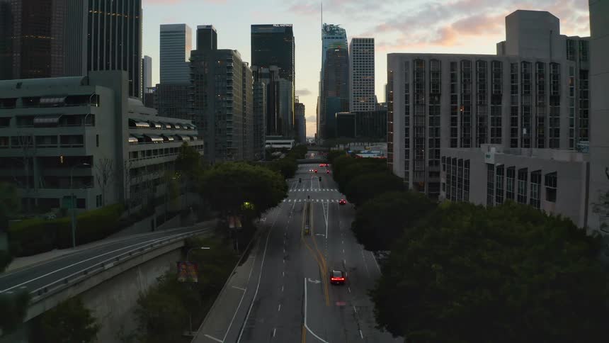 Slow aerial view of a downtown city at dusk