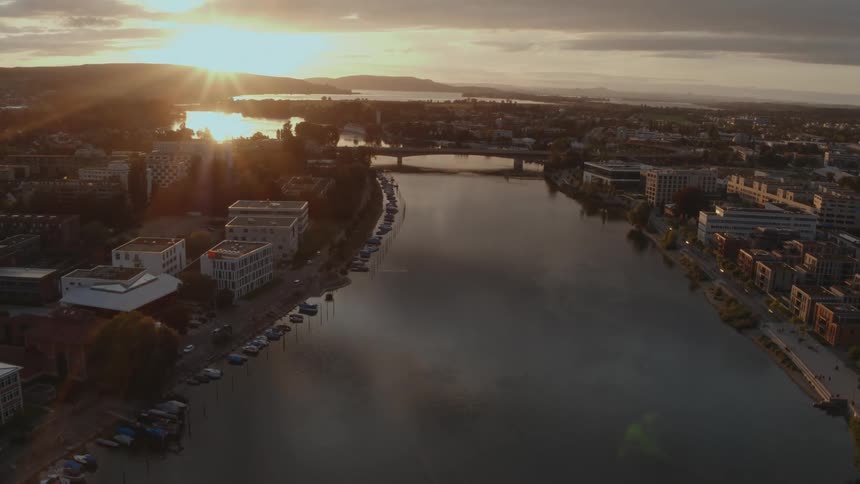 A city on the river is show as the sun is setting
