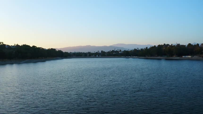 Aerial view of a lake is displayed at dusk