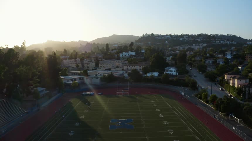 A university football stadium is surrounded by dense neighborhoods
