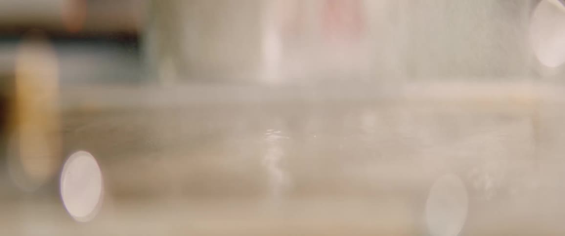 Water is spritzed inside a glass container