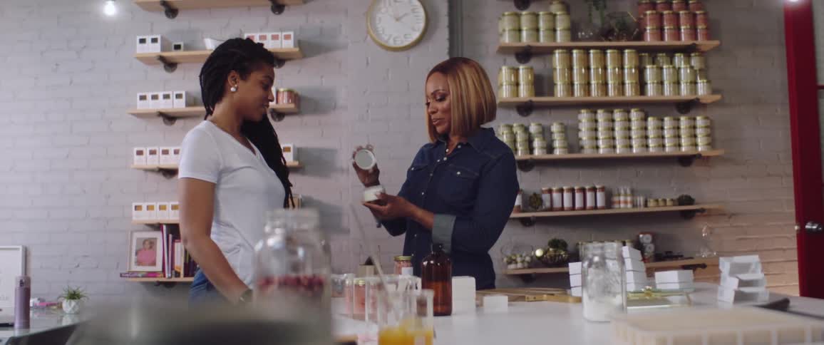 A woman smelling a product in a retail store