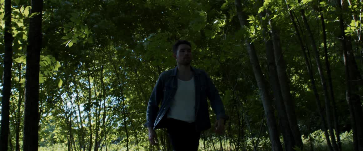 A man walking into a forest