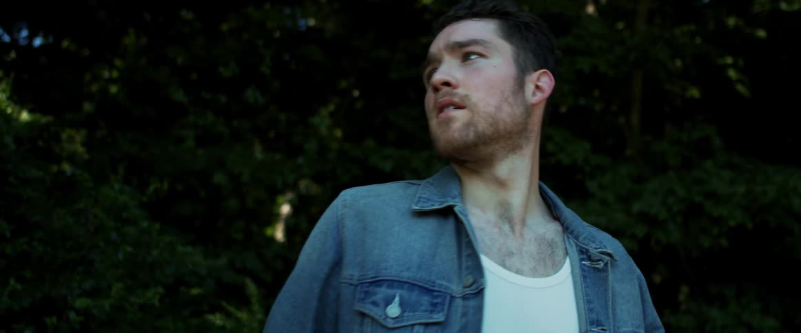 A man walking outside in the forest