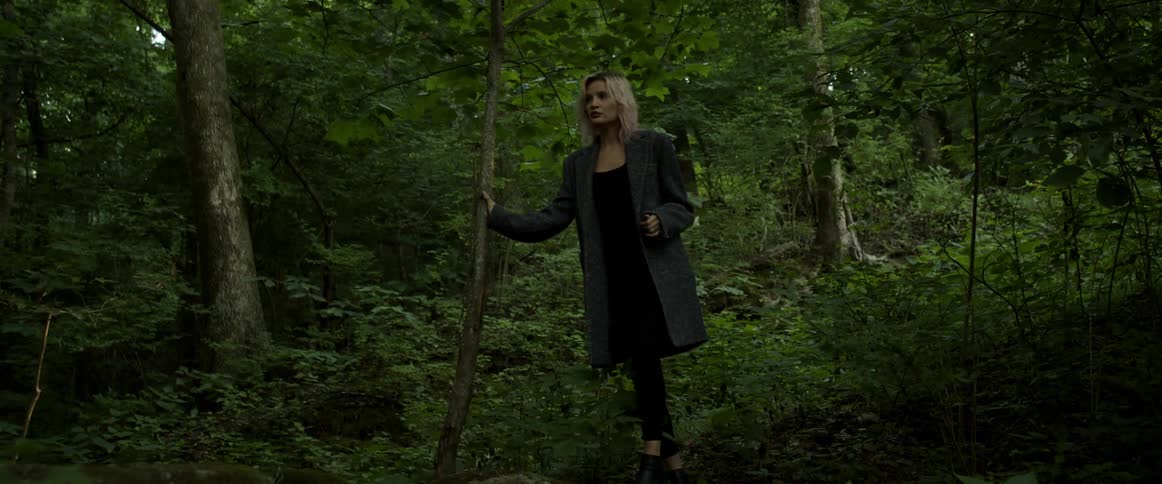 A woman walking through a forest
