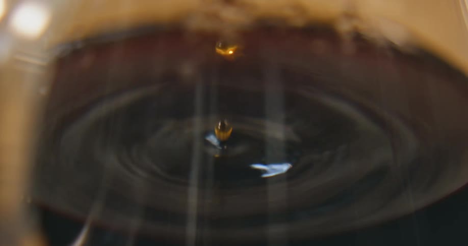 Coffee drips into a container of coffee below