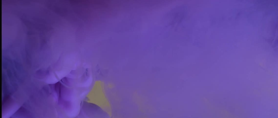 A purple powder explodes and forms a purple cloud
