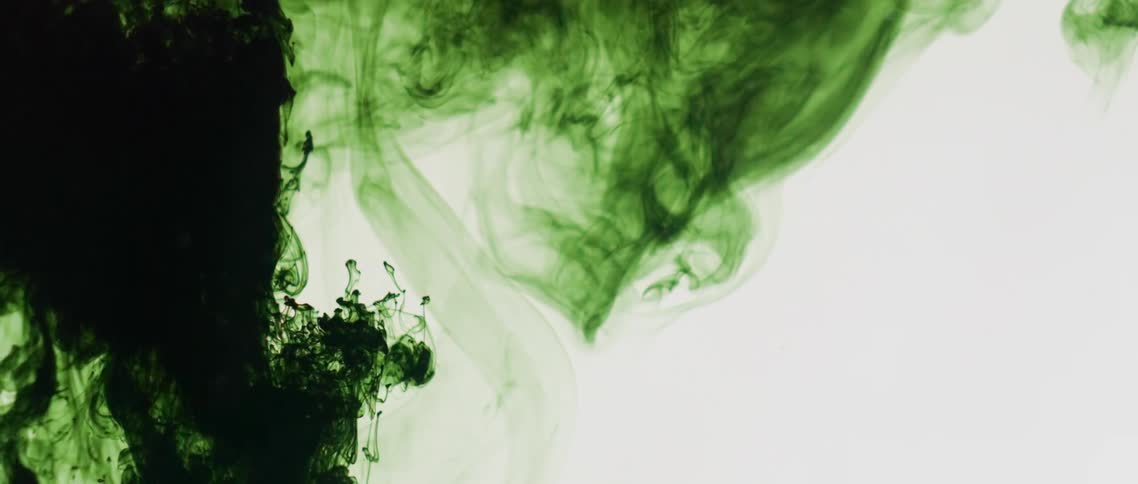 Green dye swirls through clear liquid