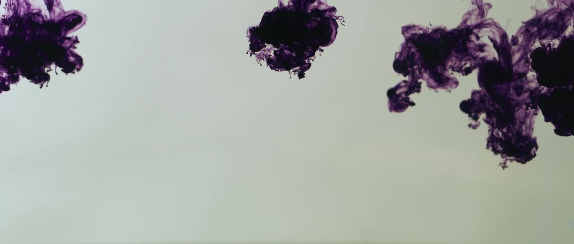 Purple ink dropping into water