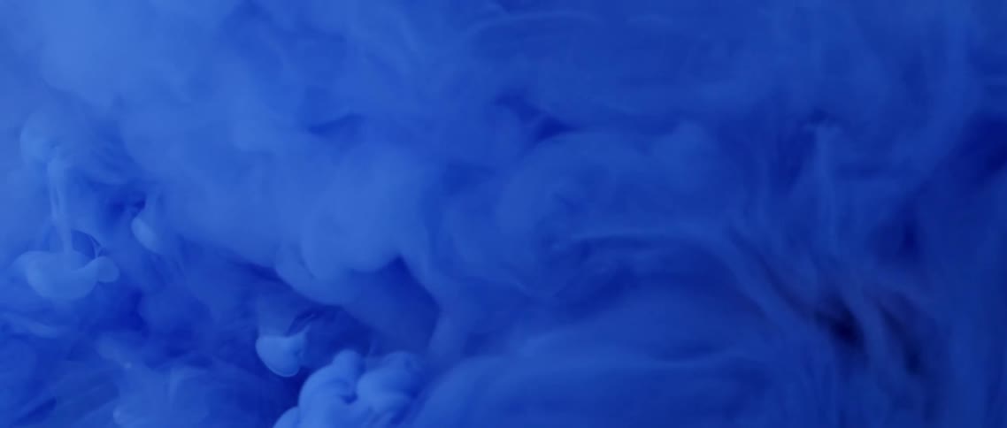 Bright deep blue ink waving and floating on water