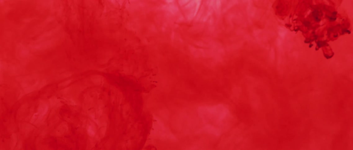 Red powder explodes and spreads in red liquid