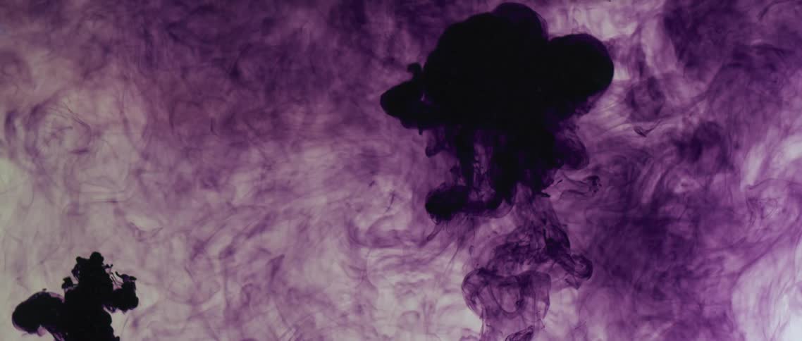 Deep dark purple ink swirling and floating up a tank of clear water