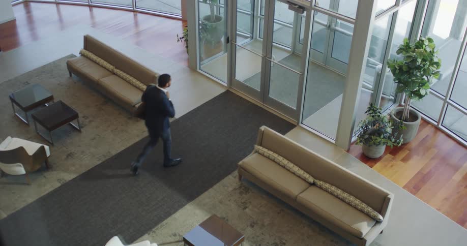 A businessman exits a building