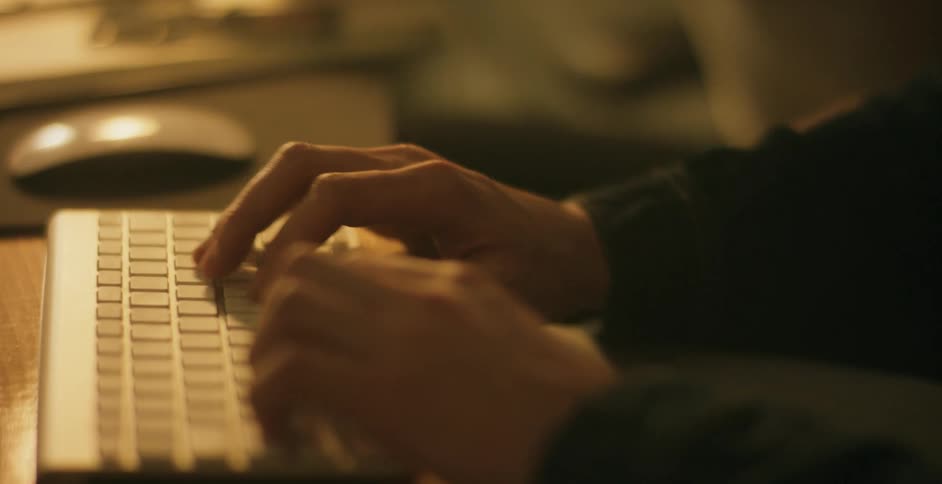 A person typing at a computer