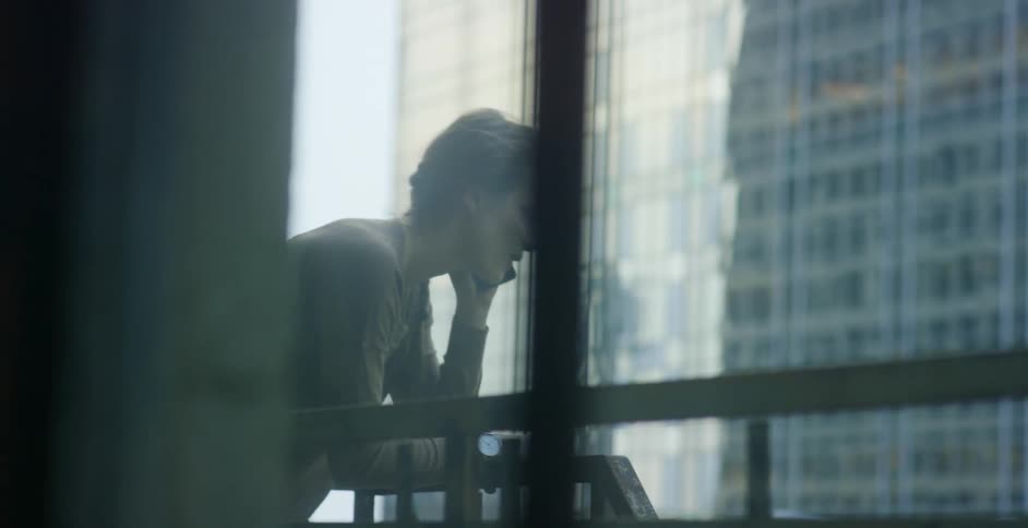 A man overlooks a balcony in the city