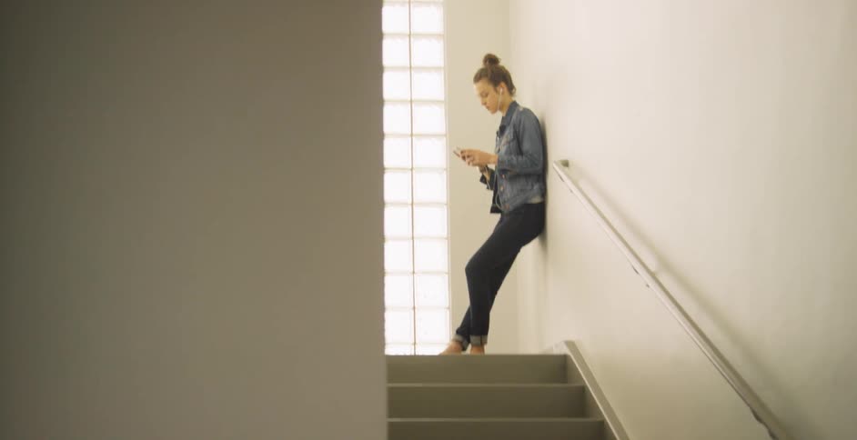 A person standing at the top of a staircase