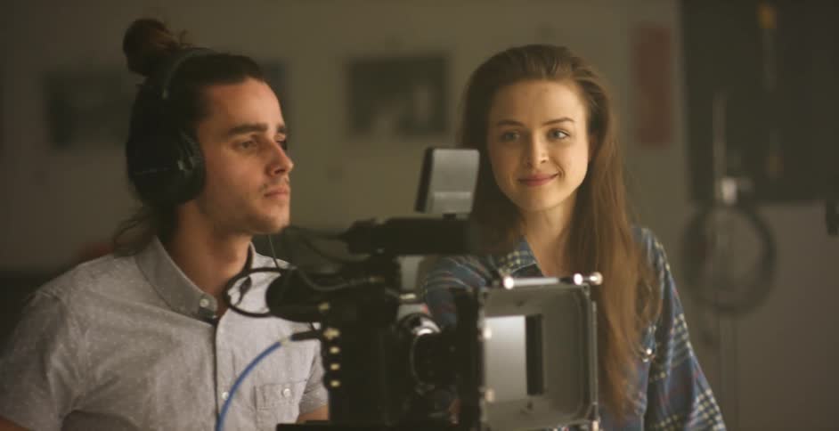 A man and woman work on a video shoot