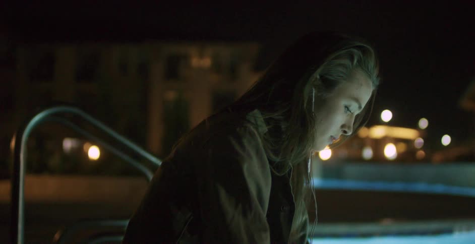 A person sitting by a pool