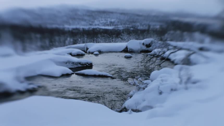 A river flows through a snow covered winter landscape