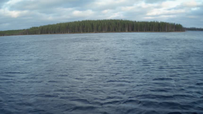 Rippling water on a lake with land in the distance