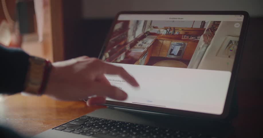 A person uses the interactive display on a laptop to move and edit a 3d image