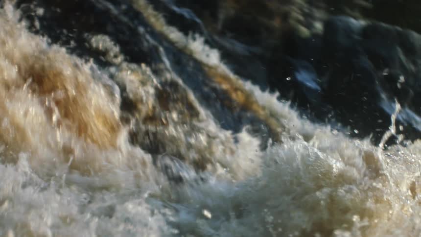 A river with a waterfall and rocks