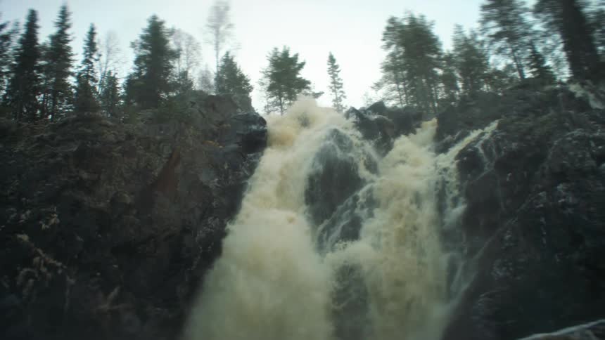 A waterfall crashed down a cliff in to a river