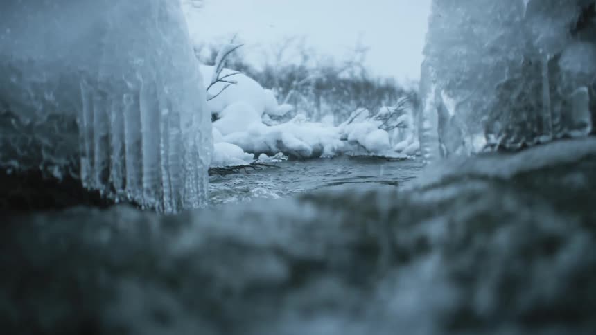 A river flowing through a snowy landscape in winter