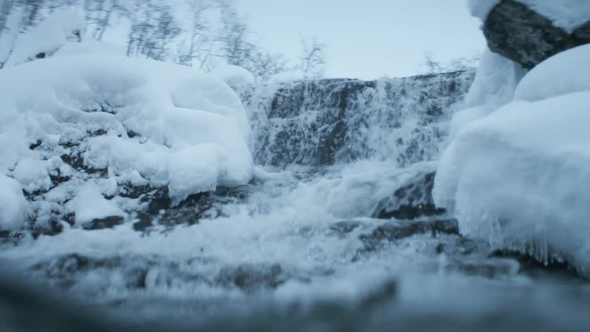 Water flowing over rocks in nature on a winter day