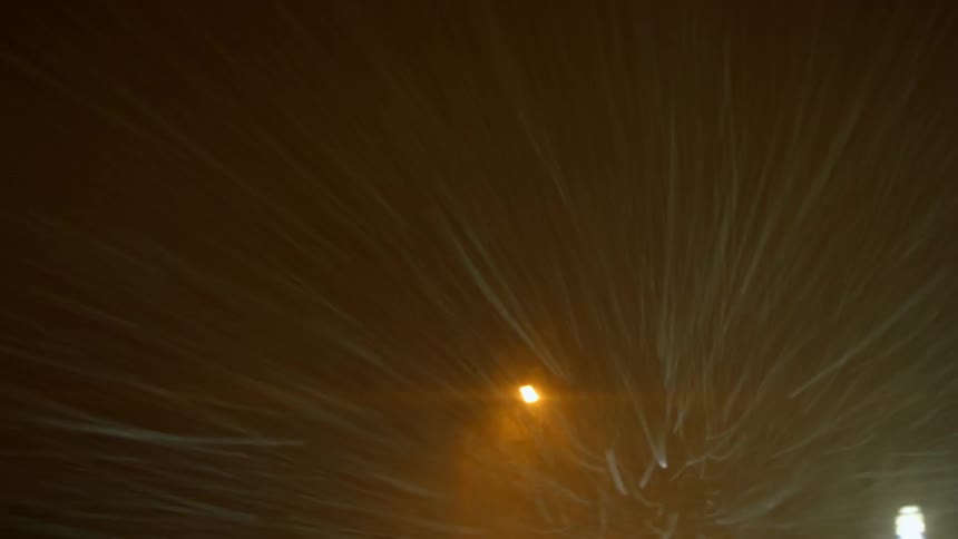Streetlights with snow blowing in the wind
