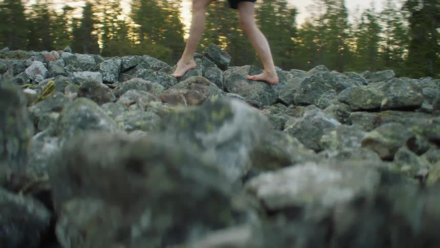 Person walking over rocks