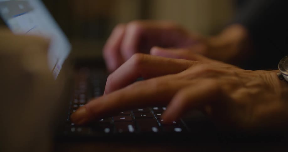 A person is typing on their laptop