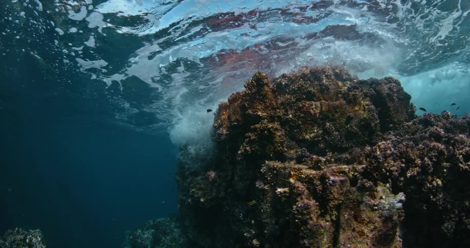 Ocean water flows around a large rock