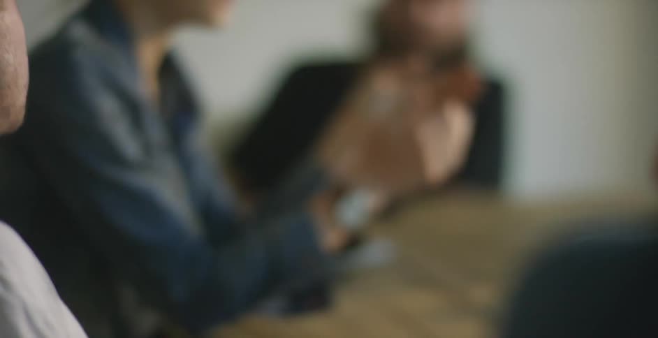 People are sitting down talking in a circle