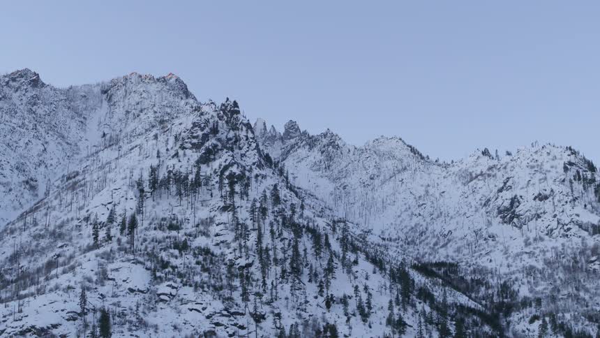 Low angle traverse along the jagged ridge of a snowy mountain range