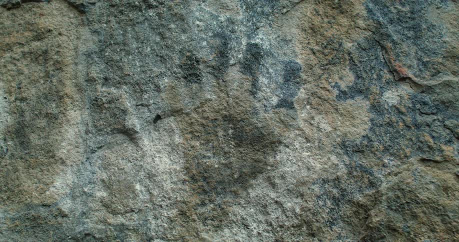 A hand print on a large stone