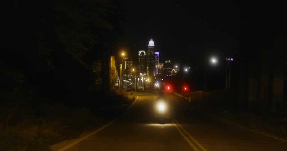 A person riding a motorcycle at night