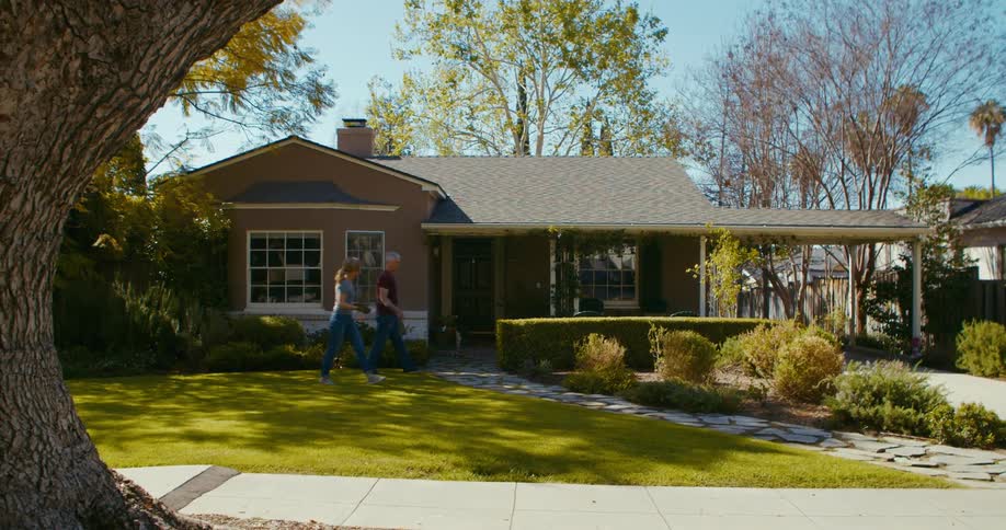 A man and woman garden outside their home