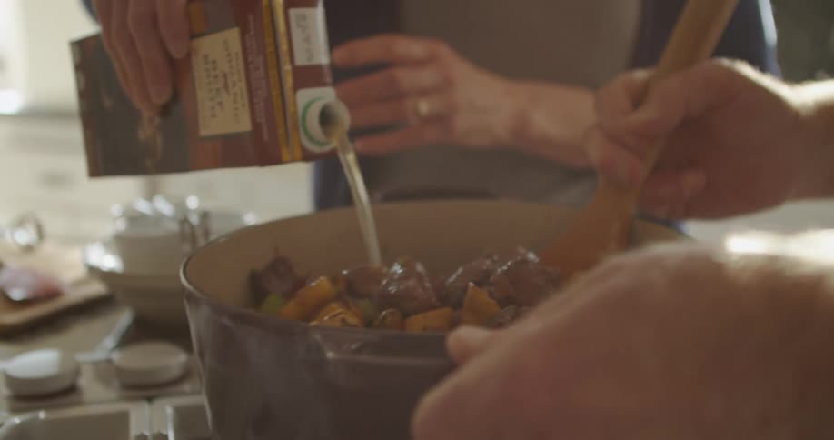 Two people are cooking in the kitchen